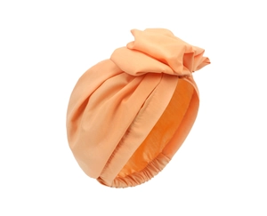 Detailed view of pink pleated turban hat featuring a decorative top knot flower design