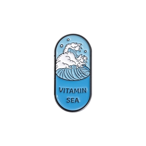 Cartoon enamel pin featuring ocean waves and Vitamin Sea text on polished metal badge