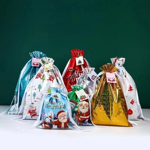Assorted Christmas drawstring gift bags with Santa, penguin, and tree festive patterns
