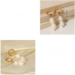 Detailed macro view of vintage baroque freshwater pearl earrings in gold titanium steel