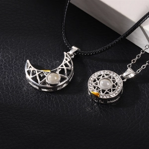 Detail of sun and moon magnetic necklaces with 100 languages projection stone charms