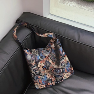 Close-up of vintage floral jacquard tote bag with traditional Chinese brocade patterns