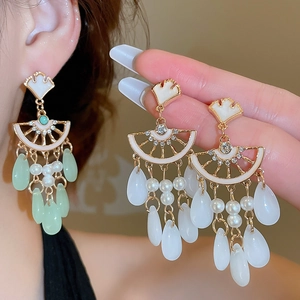 Detailed close-up of vintage ginkgo leaf tassel earrings with pearls and teardrop crystals