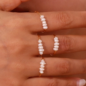 Detailed view of 18K gold-plated stainless steel rings with natural freshwater pearls