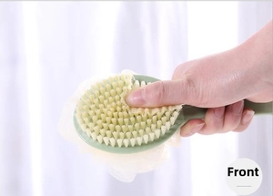 Close-up of dual-sided bath brush with soft bristles and white loofah in green handle