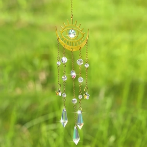 Detail of golden moon suncatcher with sparkling crystal prisms and star accents