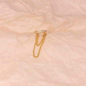 Close-up of gold S925 sterling silver ear cuff with sparkling crystals and double chains