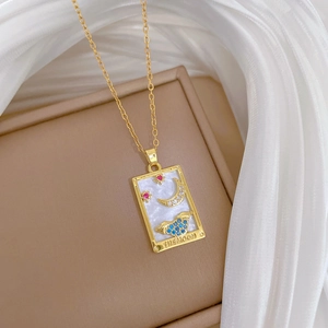 Close-up of a gold Tarot necklace with The Moon engraving and colorful crystals