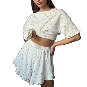 Two-piece white floral pajama set with ruffled shorts and rib-knit short sleeve top