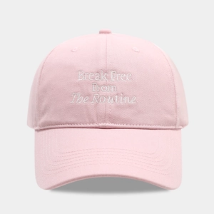 Detailed view of pink cotton baseball cap featuring Break Free From The Routine embroidery