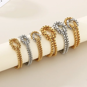 Two-piece stainless steel bracelet set with geometric knots and pearls in gold and silver