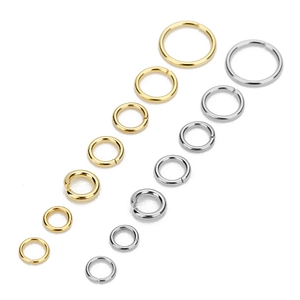 Macro shot of assorted gold and silver jump rings in various sizes for jewelry making
