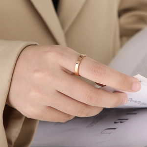 Minimalist 3mm gold stainless steel ring with a polished mirror finish on finger