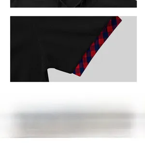 Detail of waffle knit shirt sleeve with red and blue plaid lining in black fabric