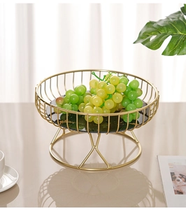 Detail of Nordic gold iron fruit basket with a chic black marble pattern base and high stand