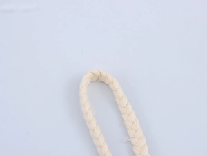 Detailed macro shot showing the beige braided rope strap on the printed maxi dress