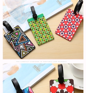 Detailed view of colorful PVC luggage tags with stylish patterns and secure black straps