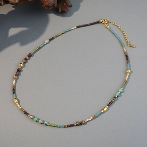 Handmade bohemian beaded necklace with natural stones, gold accents, and lobster clasp