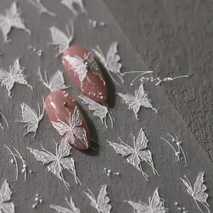3D white embossed butterfly nail stickers with realistic 3D textures on pink glitter base