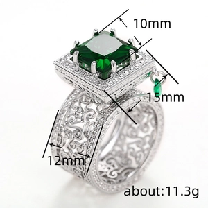 Luxury geometric zircon ring with green emerald center stone and ornate scrollwork patterns
