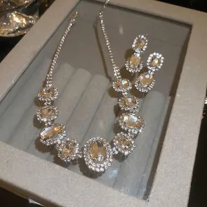 Luxury oval crystal necklace and earring set with shimmering silver finish rhinestones