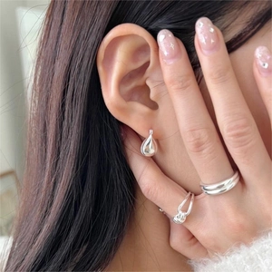 Minimalist 925 sterling silver water drop earrings and sleek rings set on model