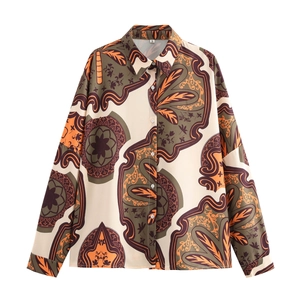 Detailed flat lay of a paisley print resort shirt with beige floral patterns and buttons