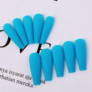 Macro view of long matte coffin press on nails in vibrant teal blue finish