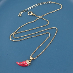 Detail of red enamel horn pendant with colorful zircons on a gold box chain necklace