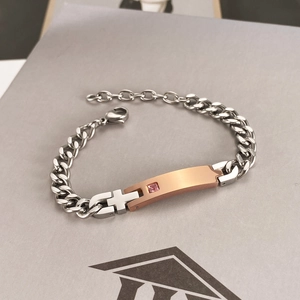 Polished silver and rose gold stainless steel bracelet with a square pink gemstone