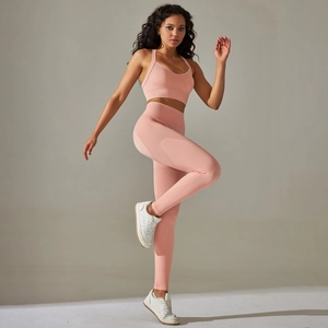 Detail of seamless knitted yoga set showing ribbed waistband and pink elastic fabric texture