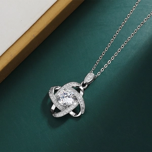 Detail of clover pendant with round central stone and pave zircons on silver chain