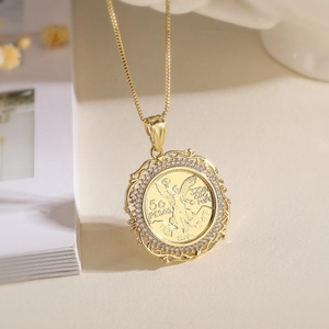 Gold coin pendant necklace with 18K gold plating and sparkling zircon border on a beige desk