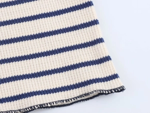 Macro view of blue and white striped knit fabric showing detailed texture and stitching