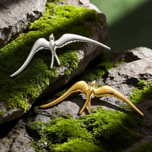 Broches élégantes en forme d'oiseau volant en acier inoxydable doré et argenté sur mousse