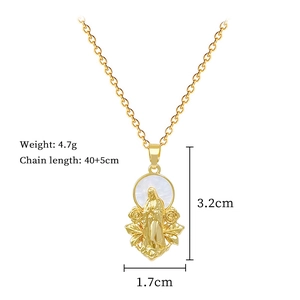 Macro shot of gold oval pendant with Virgin Mary relief and floral shell details