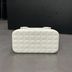 Close-up detail of white EVA beach bag bottom featuring a grid texture and non-slip feet
