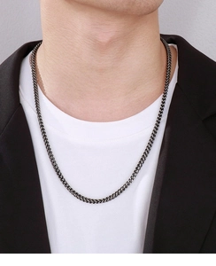 Close-up of a men's vintage gunmetal stainless steel keel chain necklace on a male model