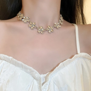 Sparkling floral silver necklace with crystals on model showing delicate neck fit