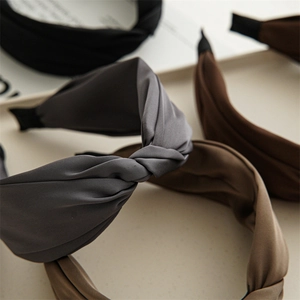 Detail of twisted knot design and matte textured fabric on a French style headband