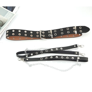 Close-up of black PU leather punk waist belt with metal eyelets and decorative chains