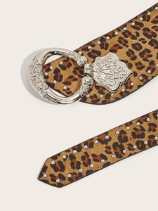 Detail of leopard print belt with silver studs and vintage engraved metal buckle