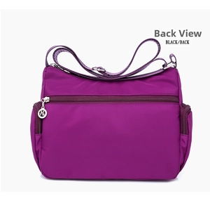 Rear view of purple waterproof nylon crossbody bag showing back zipper pocket and strap