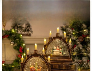 Detail of vintage bronze Christmas snow globe lamp with LED candles and snowman scene