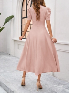 Rear view of pink short sleeve high waist midi dress showing textured fabric quality