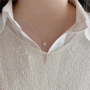 Close-up of 925 sterling silver lock necklace with crystals on model for a modern look