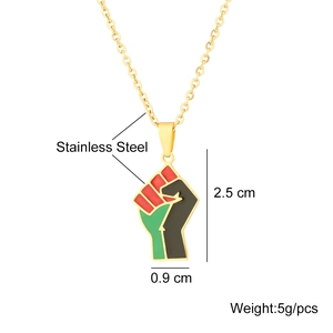 Detail view of African fist pendant in gold stainless steel with red black green enamel