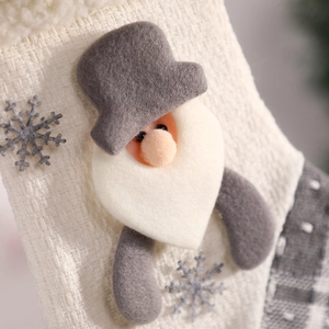 Grey and off-white knitted Christmas stocking with Santa gnome and snowflake applique