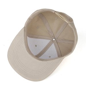 Detailed interior of the beige snapback hat featuring cotton twill and plastic closure