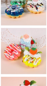 Detail of colorful artificial donut and cupcake charms with golden metal bead chains